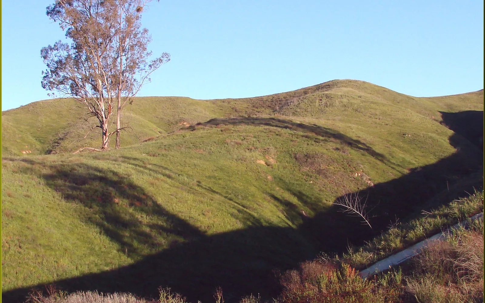 Sunrise over gently rounded hills at Crafton Hills in Yucaipa, showing the hiking and outdoor recreation landscape